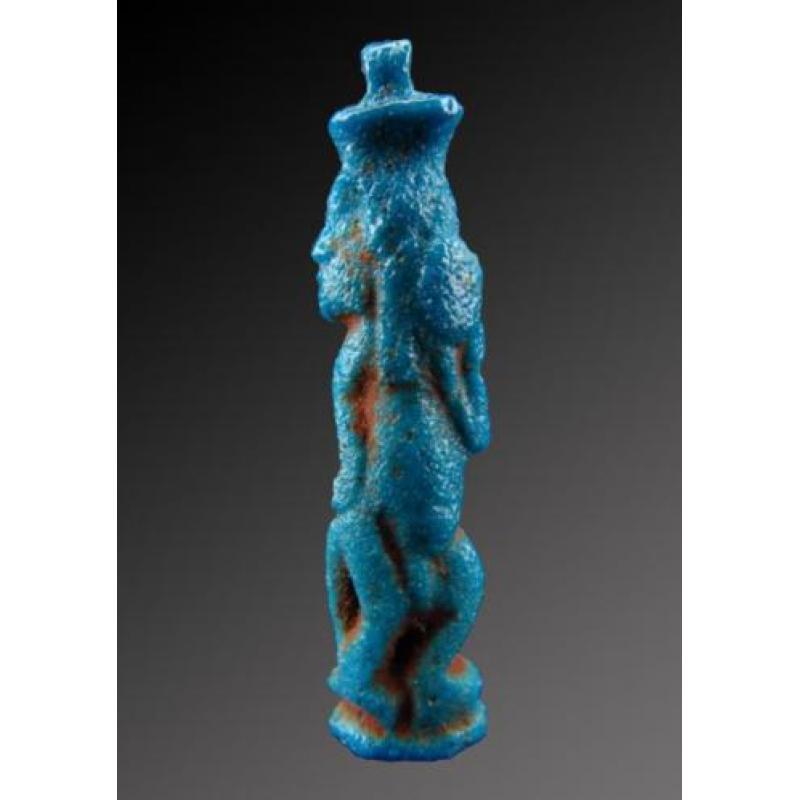 Egyptian faience amulet of Bes, dancing and playing the tamb