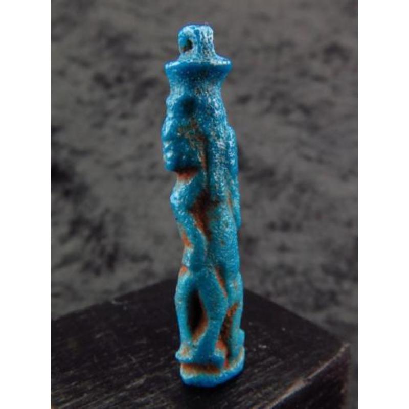 Egyptian faience amulet of Bes, dancing and playing the tamb